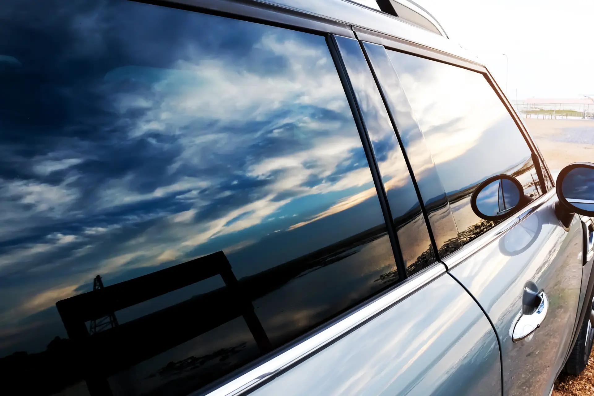 SUV side window with sky reflection