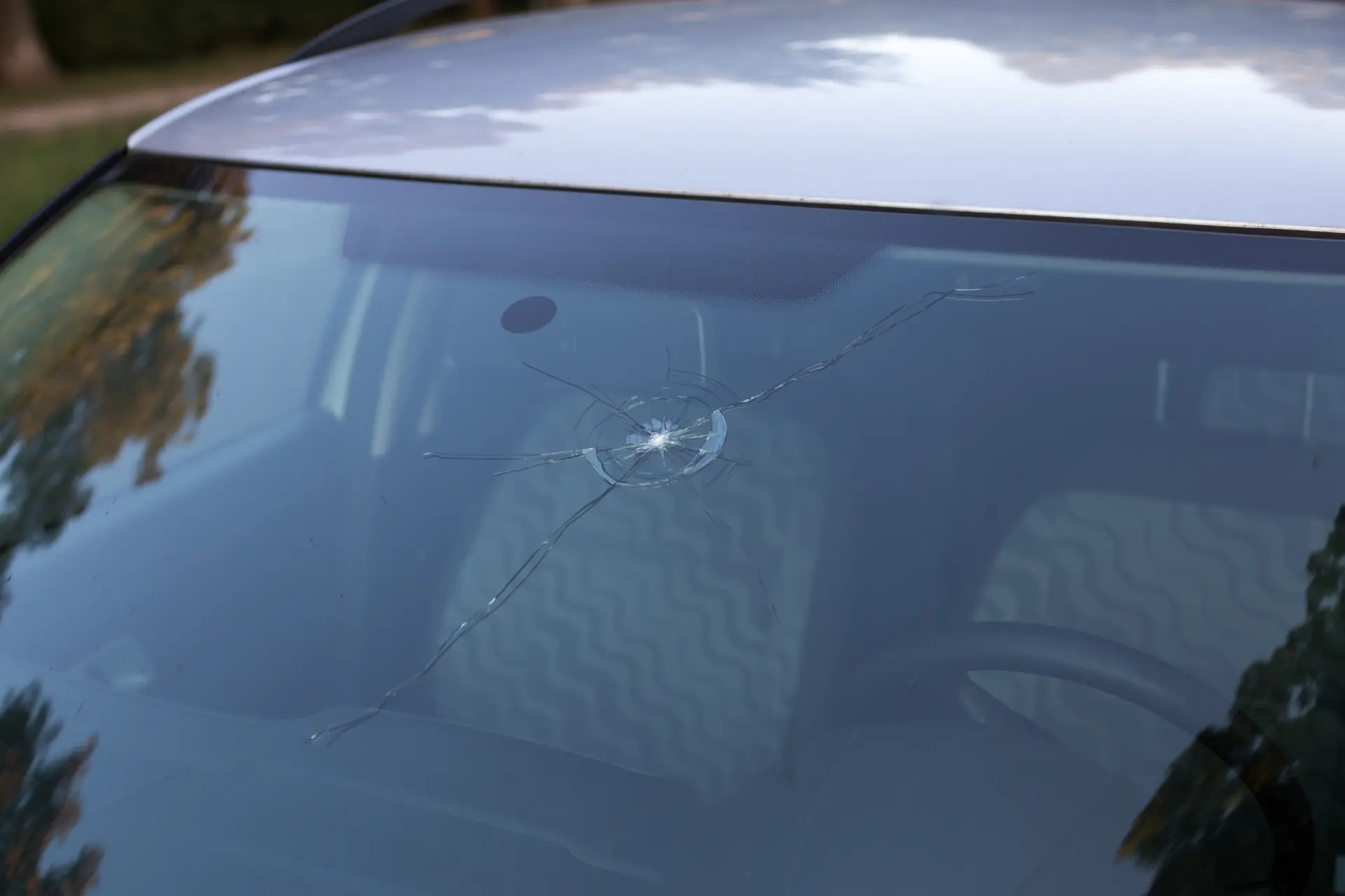 Full view of a chipped and cracked windscreen on a car