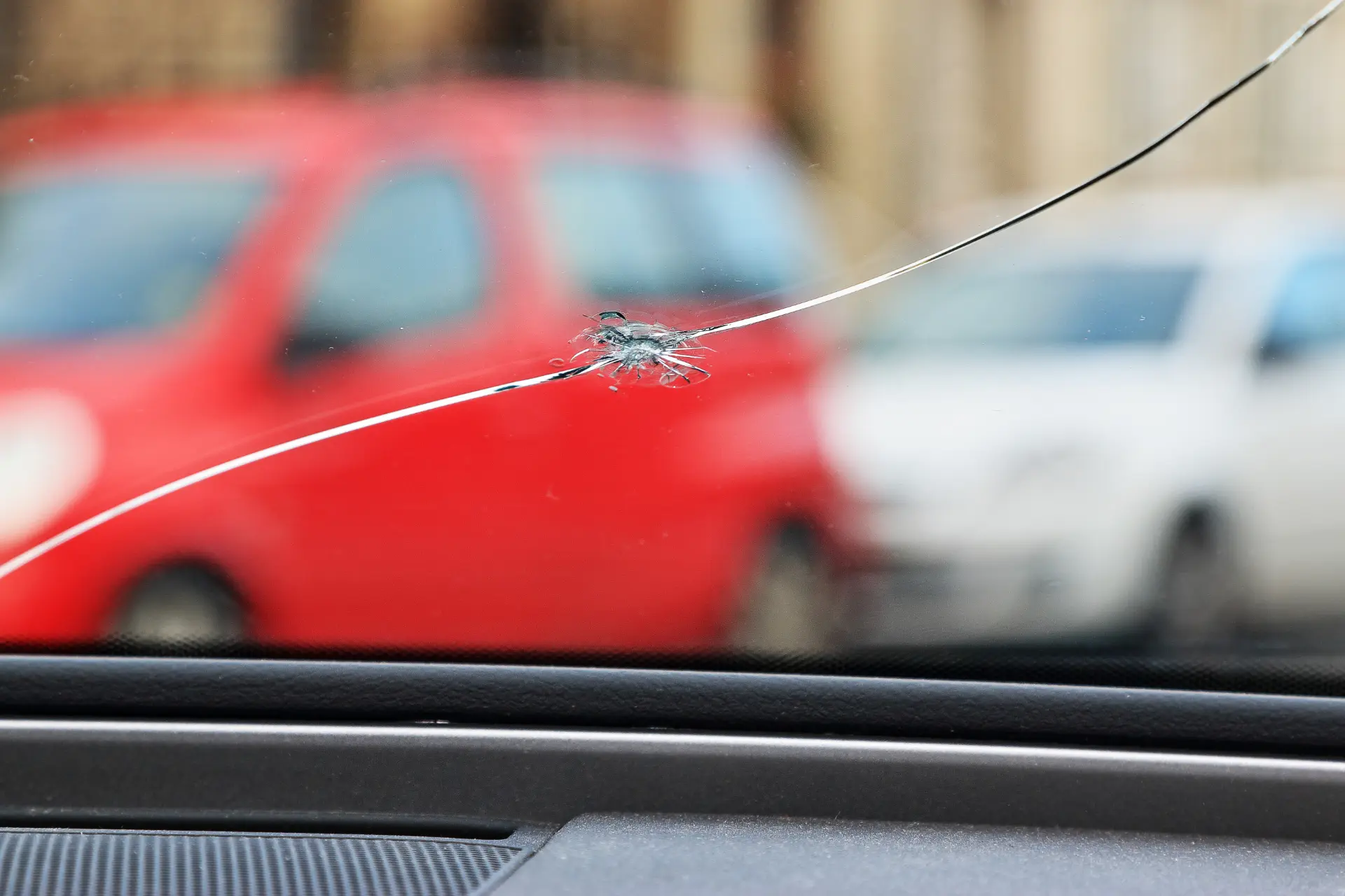 Interior view of a windscreen crack with a street background